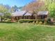 Charming brick home with lush green lawn and mature landscaping, perfect for outdoor enjoyment at 17109 Cabarrus Rd, Midland, NC 28107