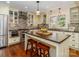 Bright kitchen features an island with seating and stainless steel appliances at 17109 Cabarrus Rd, Midland, NC 28107