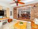 Cozy brick-walled living room with hardwood floors and an open layout to the dining area at 17109 Cabarrus Rd, Midland, NC 28107