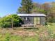 Exterior view of shed with rustic bench, metal roof, and surrounding greenery at 17109 Cabarrus Rd, Midland, NC 28107