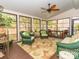 Cozy sunroom featuring wicker furniture, ceiling fan, and views of the outdoors at 17109 Cabarrus Rd, Midland, NC 28107