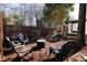 Backyard seating area around a fire pit, with nice landscaping surrounding it at 1847 Woodland Dr, Charlotte, NC 28205