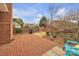The backyard features a brick wall, patio, seating, and landscaping at 1921 Wexford Ct, Gastonia, NC 28054