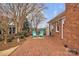 A charming brick patio includes two blue chairs with bright yellow cushions and manicured landscaping at 1921 Wexford Ct, Gastonia, NC 28054
