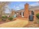 This backyard features a well-maintained lawn, brick patio, grill, and mature landscaping at 1921 Wexford Ct, Gastonia, NC 28054