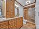 The bathroom features a granite countertop, wood cabinets and a tiled walk-in shower with glass door at 1921 Wexford Ct, Gastonia, NC 28054