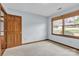 Bright bedroom features wood trim, neutral carpet, and natural light streaming through a window with wood blinds at 1921 Wexford Ct, Gastonia, NC 28054