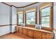 Sunlit breakfast nook featuring a window seat with storage and views of the landscaped front yard at 1921 Wexford Ct, Gastonia, NC 28054