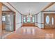 Spacious dining room featuring hard wood floors, a bay window, and a view into the kitchen at 1921 Wexford Ct, Gastonia, NC 28054