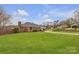 Classic brick home with a lush green lawn and winding driveway at 1921 Wexford Ct, Gastonia, NC 28054