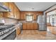 Cozy kitchen with stainless steel appliances, wood cabinets, and breakfast nook at 1921 Wexford Ct, Gastonia, NC 28054