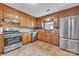 Traditional kitchen features stainless steel appliances, tile floors and plenty of cabinet space at 1921 Wexford Ct, Gastonia, NC 28054