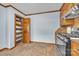 Kitchen area featuring a pantry with wooden shelves, stainless steel appliances, and tile flooring at 1921 Wexford Ct, Gastonia, NC 28054