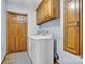 Functional laundry room with white appliances, overhead cabinets, and a decorative rug at 1921 Wexford Ct, Gastonia, NC 28054
