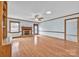 Open-concept living room with hardwood floors, brick fireplace, and ample natural light at 1921 Wexford Ct, Gastonia, NC 28054