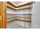 Open pantry with wooden shelving at 1921 Wexford Ct, Gastonia, NC 28054