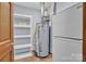 Practical utility room with a water heater, shelving, and access to the home's systems at 1921 Wexford Ct, Gastonia, NC 28054