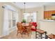 Sunny dining area with wooden table set and a cozy sofa under a large window at 1965 Charlotte Hwy # 401, Mooresville, NC 28115