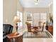 Bright dining room featuring stylish decor, a ceiling fan, and three large windows at 1965 Charlotte Hwy # 401, Mooresville, NC 28115