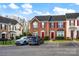 View of townhomes with red shutters, neat landscaping, and car parking at 1965 Charlotte Hwy # 401, Mooresville, NC 28115