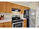 Traditional kitchen featuring wood cabinets, laminate countertops, and stainless steel appliances at 1965 Charlotte Hwy # 401, Mooresville, NC 28115