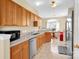 Well-lit kitchen with wooden cabinetry and a view into the dining area at 1965 Charlotte Hwy # 401, Mooresville, NC 28115