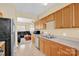 Functional kitchen with wooden cabinets, appliances, and view to the living room at 1965 Charlotte Hwy # 401, Mooresville, NC 28115