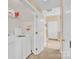 Convenient laundry room area with washer, dryer, and shelving at 1965 Charlotte Hwy # 401, Mooresville, NC 28115