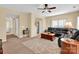 Spacious living room boasts neutral walls, carpeted floors, and modern ceiling fan at 1965 Charlotte Hwy # 401, Mooresville, NC 28115