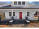 Inviting front porch with seating, black and white accents, and freshly painted finishes at 201 Pleasant Ave, Stanfield, NC 28163