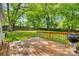 Wood deck with grill overlooks a large backyard perfect for outdoor activities and relaxation at 210 Knox St, Clover, SC 29710