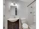 Bright bathroom features a white toilet, shower and a vanity with espresso-stained cabinets at 210 Knox St, Clover, SC 29710