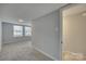 Bedroom with neutral walls and carpet, featuring windows for natural light at 210 Knox St, Clover, SC 29710