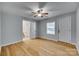 Bedroom with hardwood floors, ceiling fan, and ensuite bathroom ready for your design touches at 210 Knox St, Clover, SC 29710