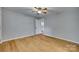 Spacious bedroom with hardwood floors and ample natural light, ready for personalization at 210 Knox St, Clover, SC 29710