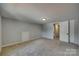 Bedroom with neutral walls and carpet, featuring a closet and hallway access at 210 Knox St, Clover, SC 29710