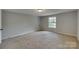 Bedroom with neutral walls and carpet, featuring a window at 210 Knox St, Clover, SC 29710