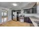 Modern kitchen with stainless steel appliances, dark cabinets, and granite countertops at 210 Knox St, Clover, SC 29710