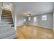 Spacious living room features hardwood floors, a ceiling fan, and stairway access to the second floor at 210 Knox St, Clover, SC 29710