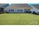 Large backyard with lush green grass and a beautiful covered patio at 22014 Finworthy Ln, Huntersville, NC 28078