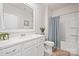 Bathroom featuring a tub-shower combo, white cabinets, and a large mirror at 22014 Finworthy Ln, Huntersville, NC 28078