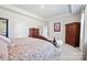 Spacious bedroom featuring a floral patterned bedspread, tray ceiling, and wood furniture at 22014 Finworthy Ln, Huntersville, NC 28078