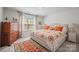 Bright bedroom featuring a large window, a comfortable bed and stylish decor at 22014 Finworthy Ln, Huntersville, NC 28078