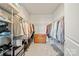 Walk-in closet with hanging racks, shelving, and a wooden dresser at 22014 Finworthy Ln, Huntersville, NC 28078