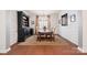 Dining room features an elegant china cabinet, wood floors, and natural light at 22014 Finworthy Ln, Huntersville, NC 28078