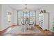 Elegant dining area with a round table, stylish chairs, and a charming chandelier at 22014 Finworthy Ln, Huntersville, NC 28078