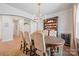 Dining room with built-in hutch, hardwood floors, elegant dining set, and modern chandelier at 22014 Finworthy Ln, Huntersville, NC 28078