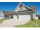 Attractive home with a spacious driveway, well-kept lawn, and complementary exterior finishes at 22014 Finworthy Ln, Huntersville, NC 28078