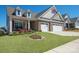 Charming home featuring brick accents, manicured lawn, and a delightful front porch at 22014 Finworthy Ln, Huntersville, NC 28078