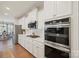 Well-equipped kitchen boasting stainless steel appliances, modern cabinetry, and stylish backsplash at 22014 Finworthy Ln, Huntersville, NC 28078